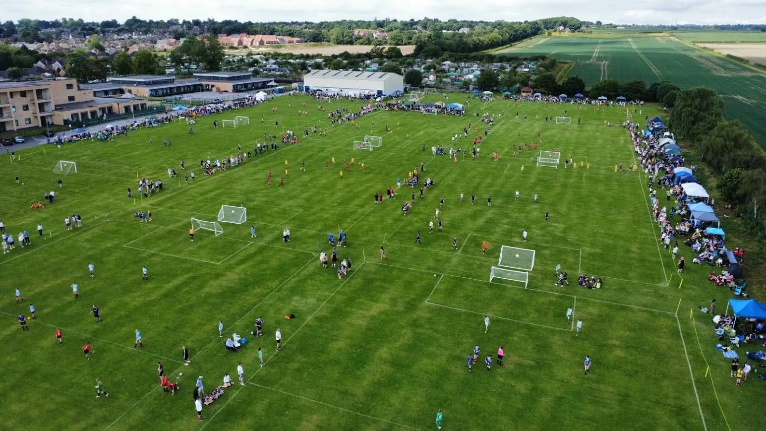 Aerial view of Bilsdon Park on a matchday, every pitch in use with teams, supporters and gazebos lining the touchlines